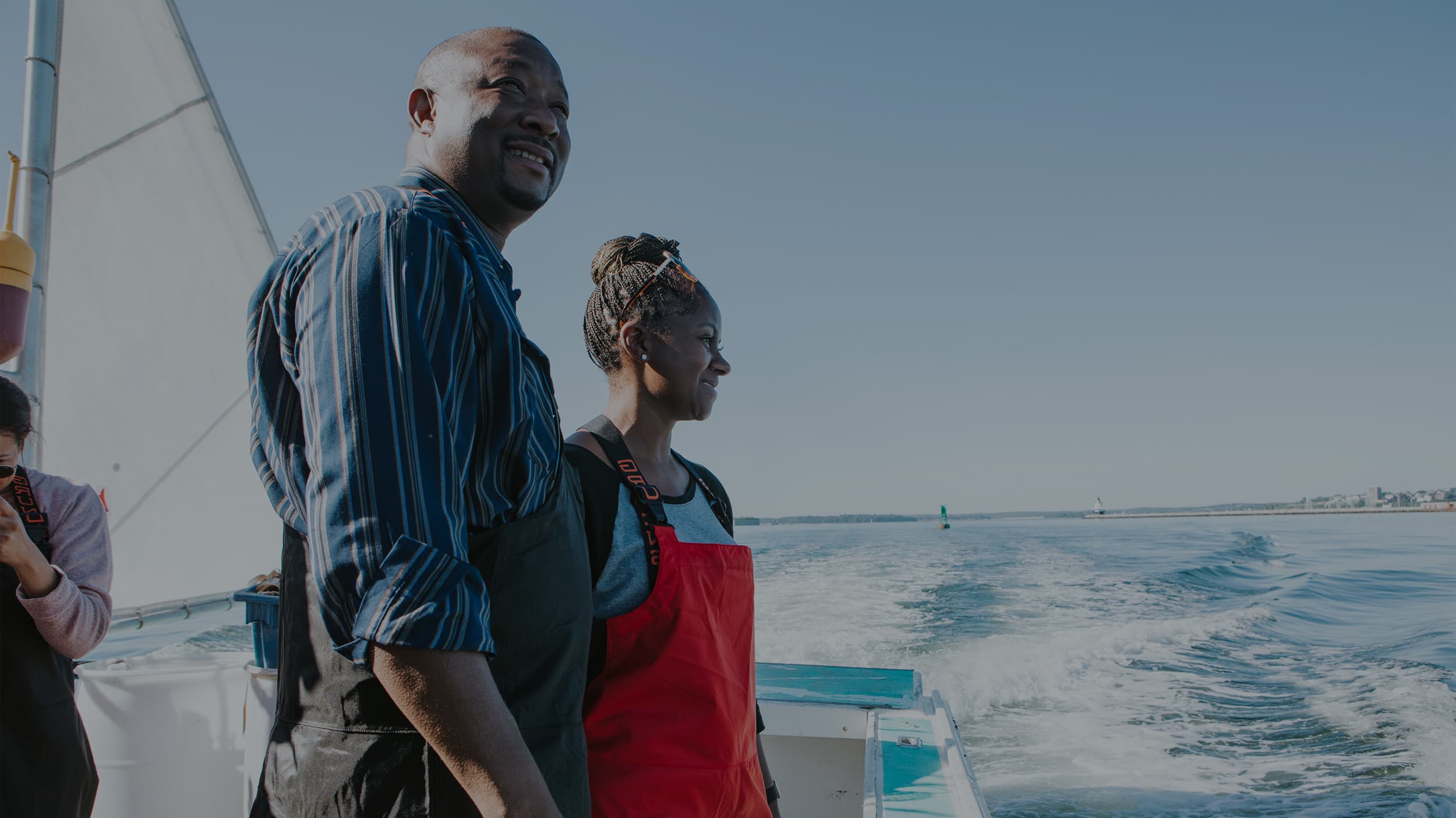 Cousins Maine Lobster Memphis owners on a boat in Maine looking at the water.